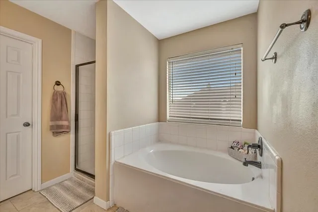a bathroom with a bathtub and shower