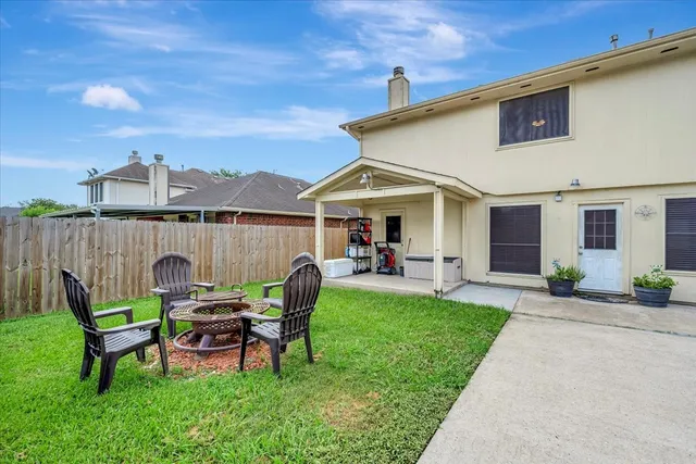 a view of a house with a yard and sitting area