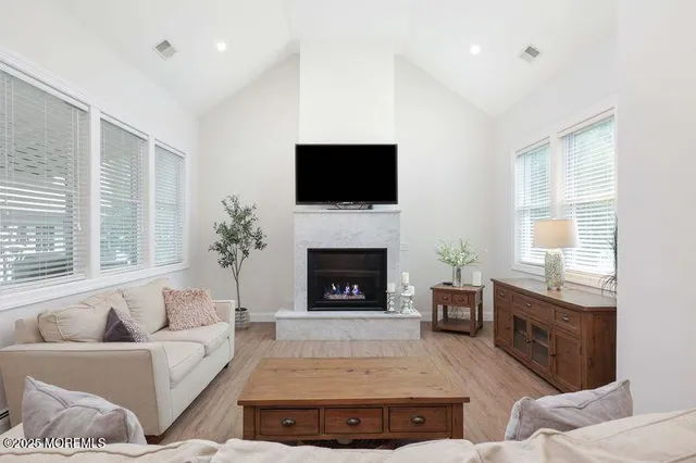 a living room with furniture flat screen tv and a fireplace