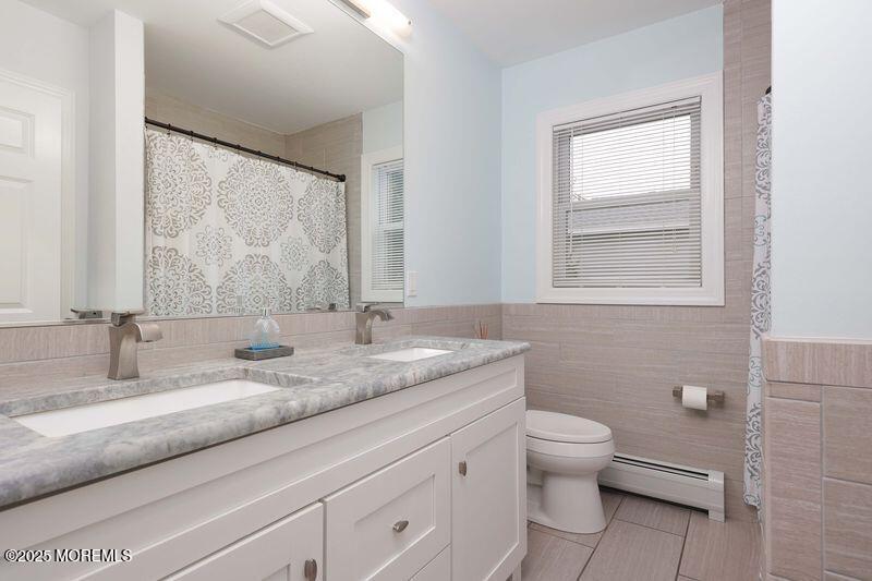 63 Carpenter Street Red Bank, NJ 07701 - Photo 16 of 35 a bathroom with a granite countertop sink a toilet and a mirror