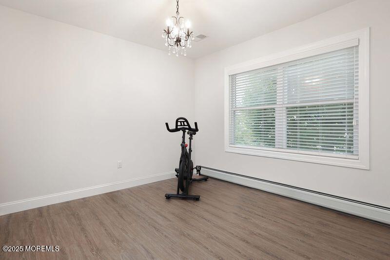 63 Carpenter Street Red Bank, NJ 07701 - Photo 17 of 35 a view of a room with gym equipment and wooden floor