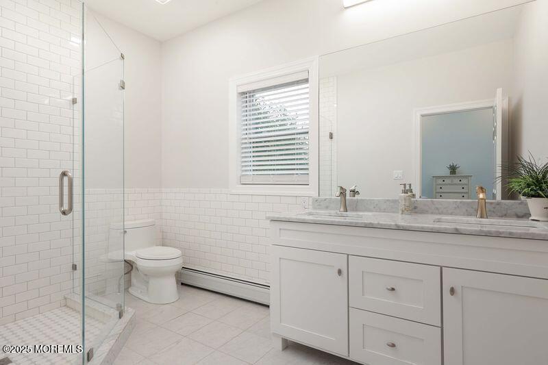 63 Carpenter Street Red Bank, NJ 07701 - Photo 22 of 35 a bathroom with a granite countertop toilet sink and mirror