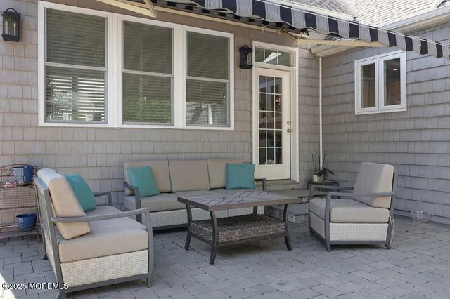 a view of a patio with couches and a potted plant on a table