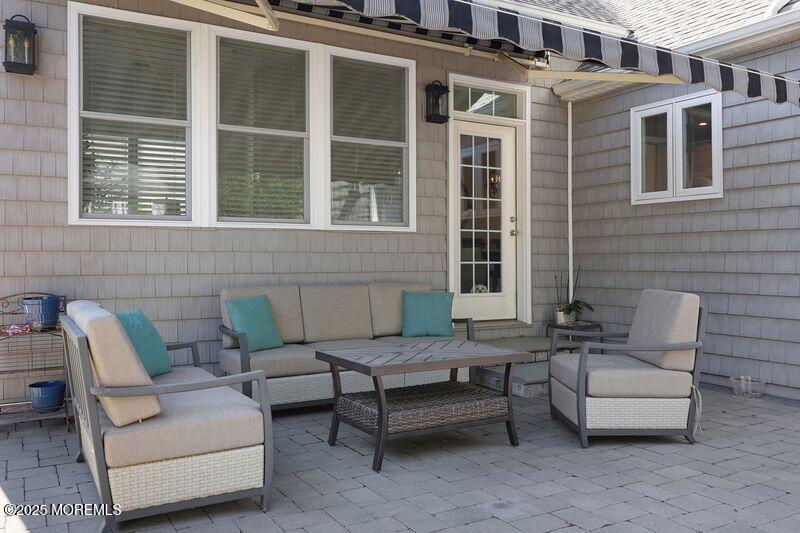 63 Carpenter Street Red Bank, NJ 07701 - Photo 31 of 35 a view of a patio with couches and a potted plant on a table