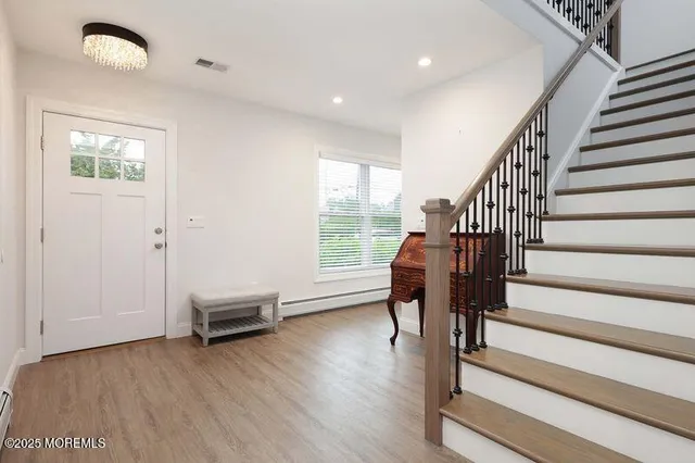 a view of entryway with wooden floor and window