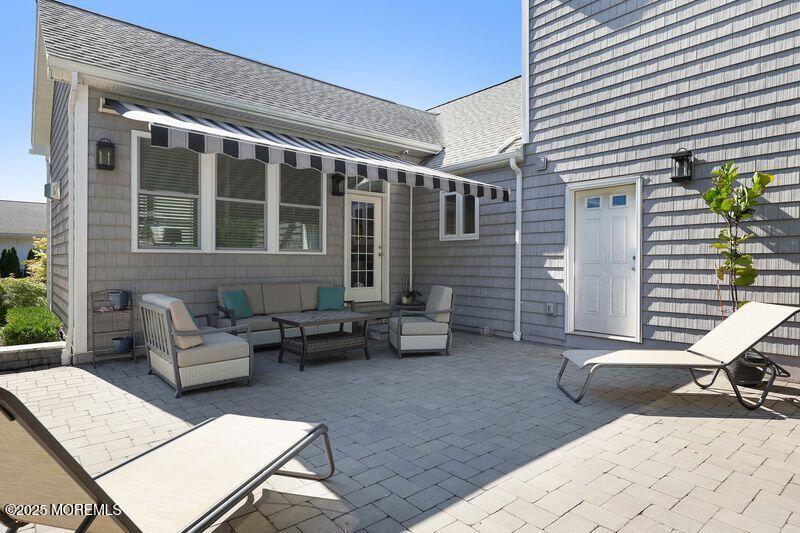 63 Carpenter Street Red Bank, NJ 07701 - Photo 10 of 35 a view of a patio with couches and a dining table and chairs with wooden floor