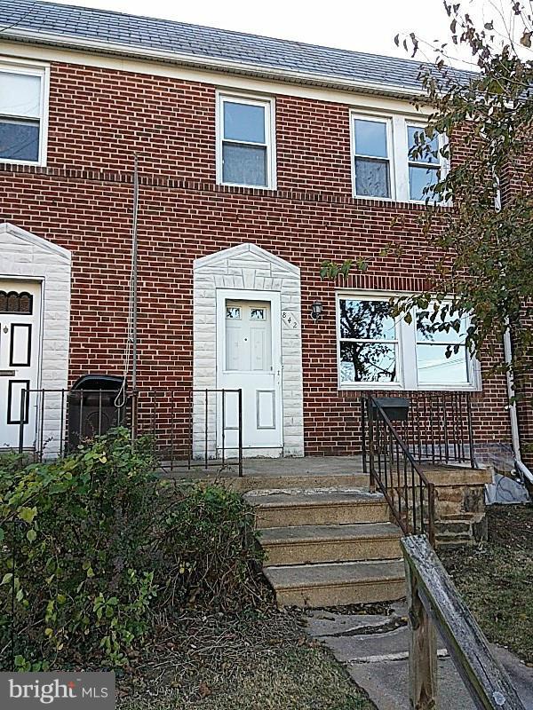 842 Braeside Road Baltimore, MD 21229 - Photo 2 of 26 a front view of a house with a garden