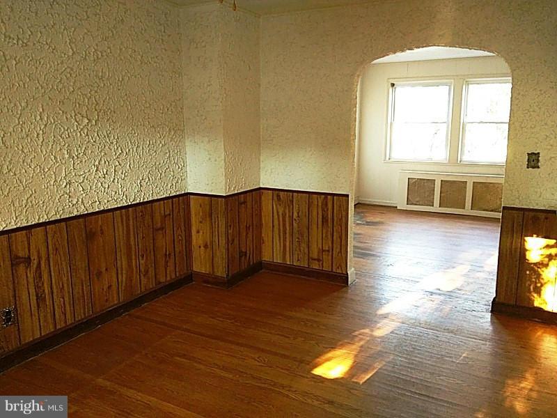 842 Braeside Road Baltimore, MD 21229 - Photo 11 of 26 a view of a room with wooden floor and a window