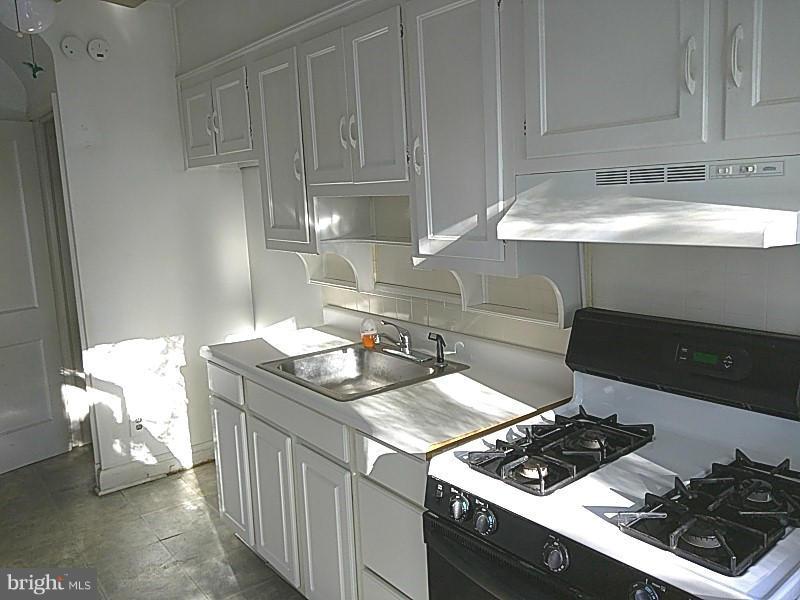842 Braeside Road Baltimore, MD 21229 - Photo 14 of 26 a kitchen with a stove and a sink