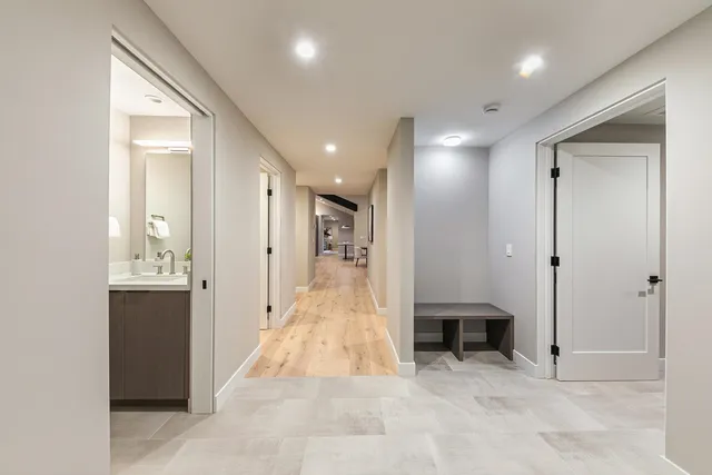 a view of a hallway with dining area and chandelier