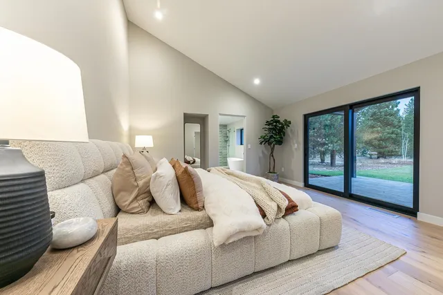 a spacious bedroom with a bed and a large window