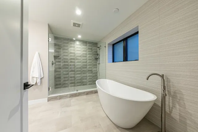 a bathroom with a bathtub and shower