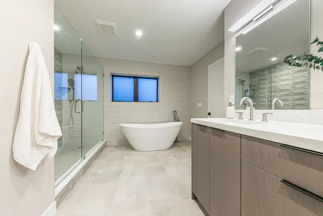 a spacious bathroom with a double vanity sink and a mirror