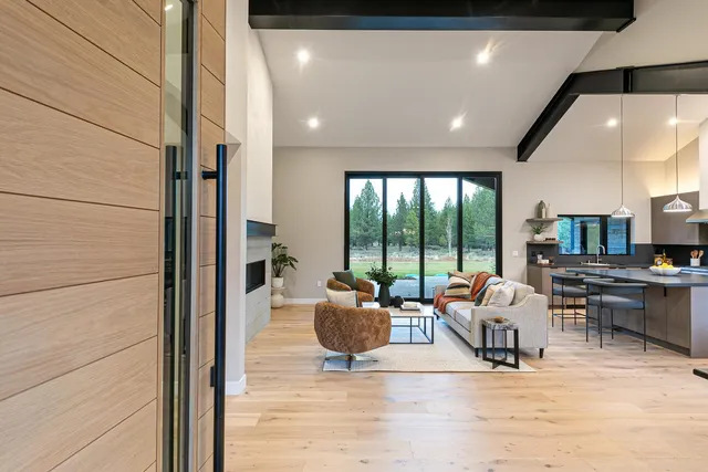 a living room with furniture and large windows