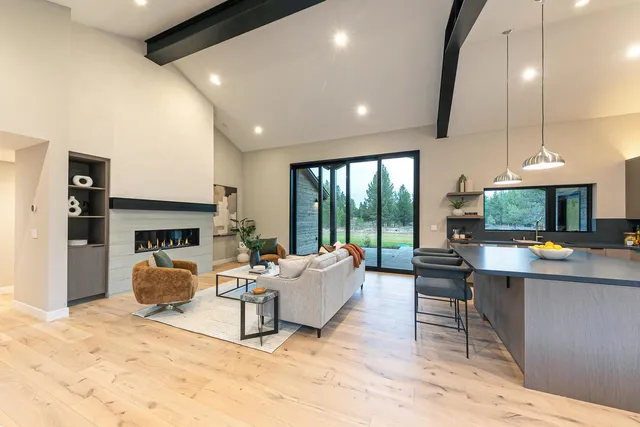 a living room with fireplace furniture and a large window