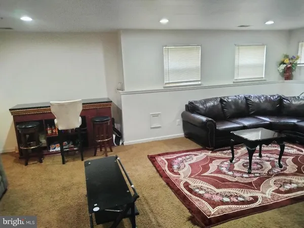 a living room with furniture and a rug
