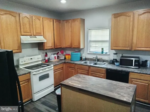 a kitchen with a stove a sink and a microwave