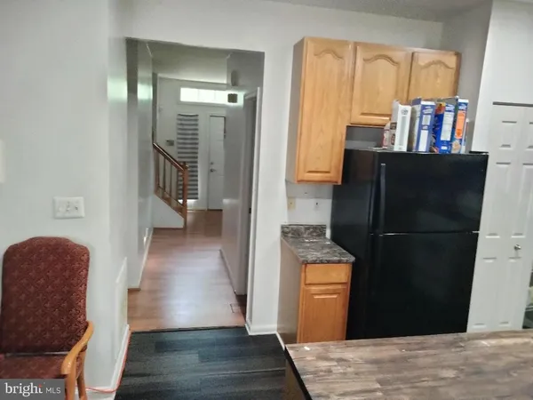 a view of a hallway with wooden floor and furniture