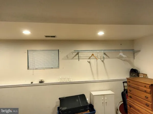 a view of a closet with wooden floor
