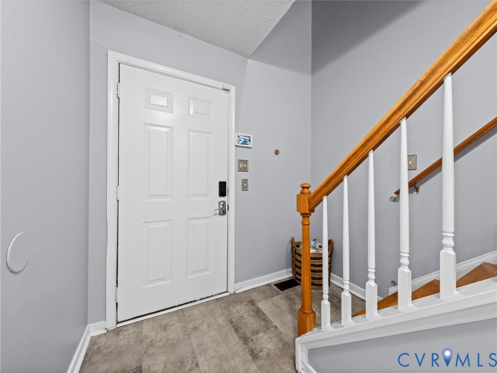 6712 Hedges Road Richmond, VA 23224 - Photo 15 of 34 Entryway featuring a paneled door with smart lock
