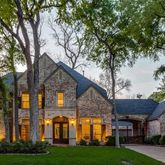 a view of residential houses with yard and green space