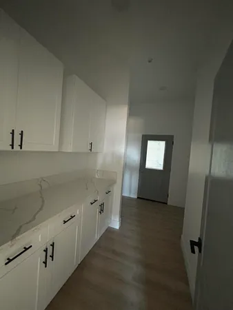 an empty room with a empty space and windows