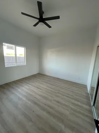 a view of a livingroom with a ceiling fan and window