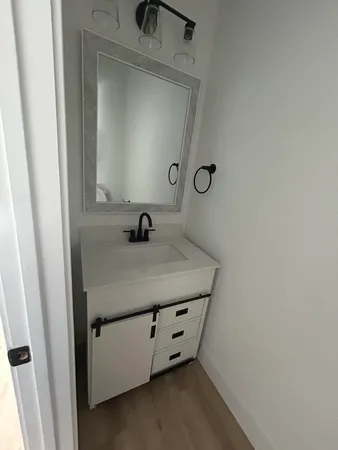 a bathroom with a sink and a mirror