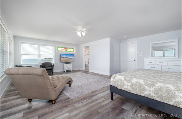 1019 Fairfield Beach Road Fairfield, CT 06824 - Photo 15 of 19 a bedroom with a bed and large window