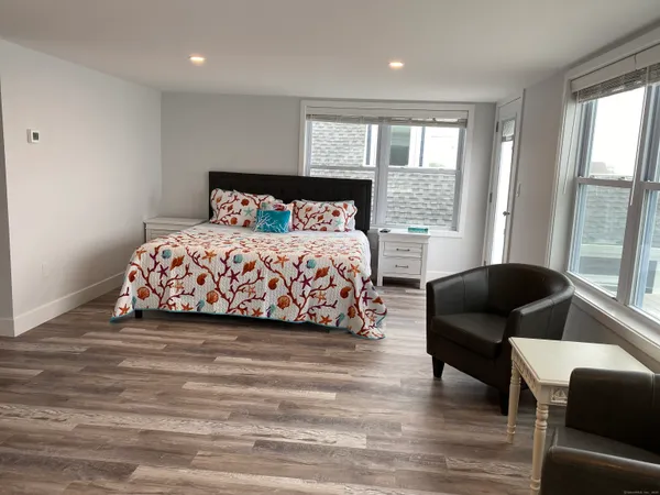 a bedroom with a bed and a couch