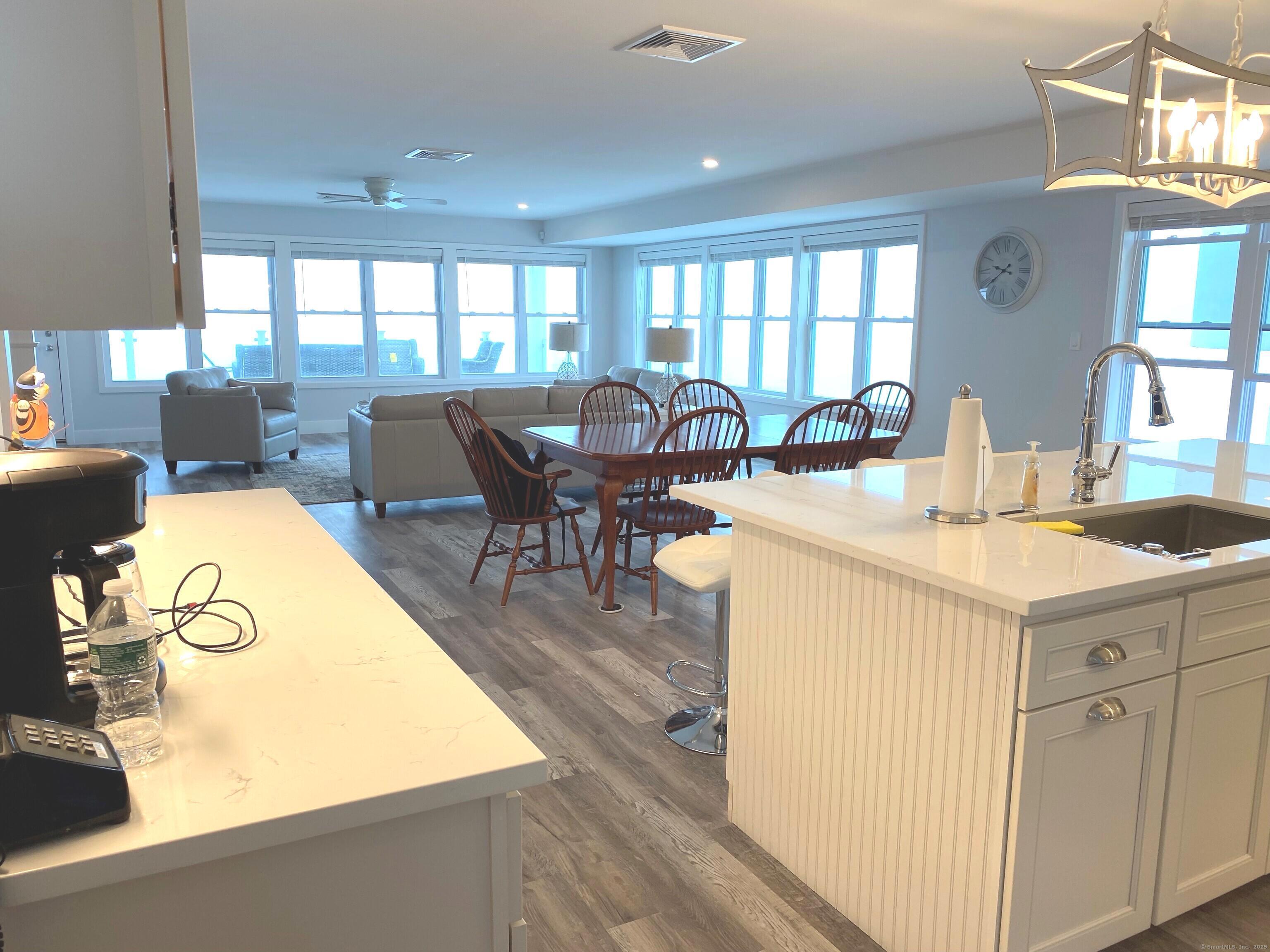 1019 Fairfield Beach Road Fairfield, CT 06824 - Photo 2 of 19 a view of a kitchen with dining table and chairs