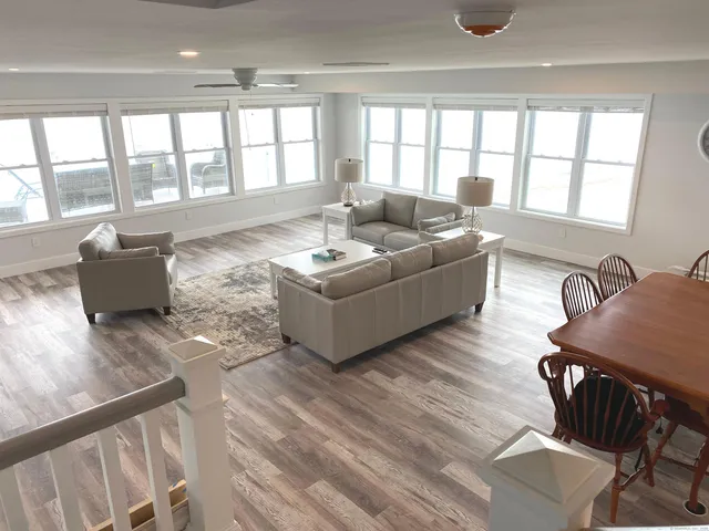 a living room with furniture and floor to ceiling windows