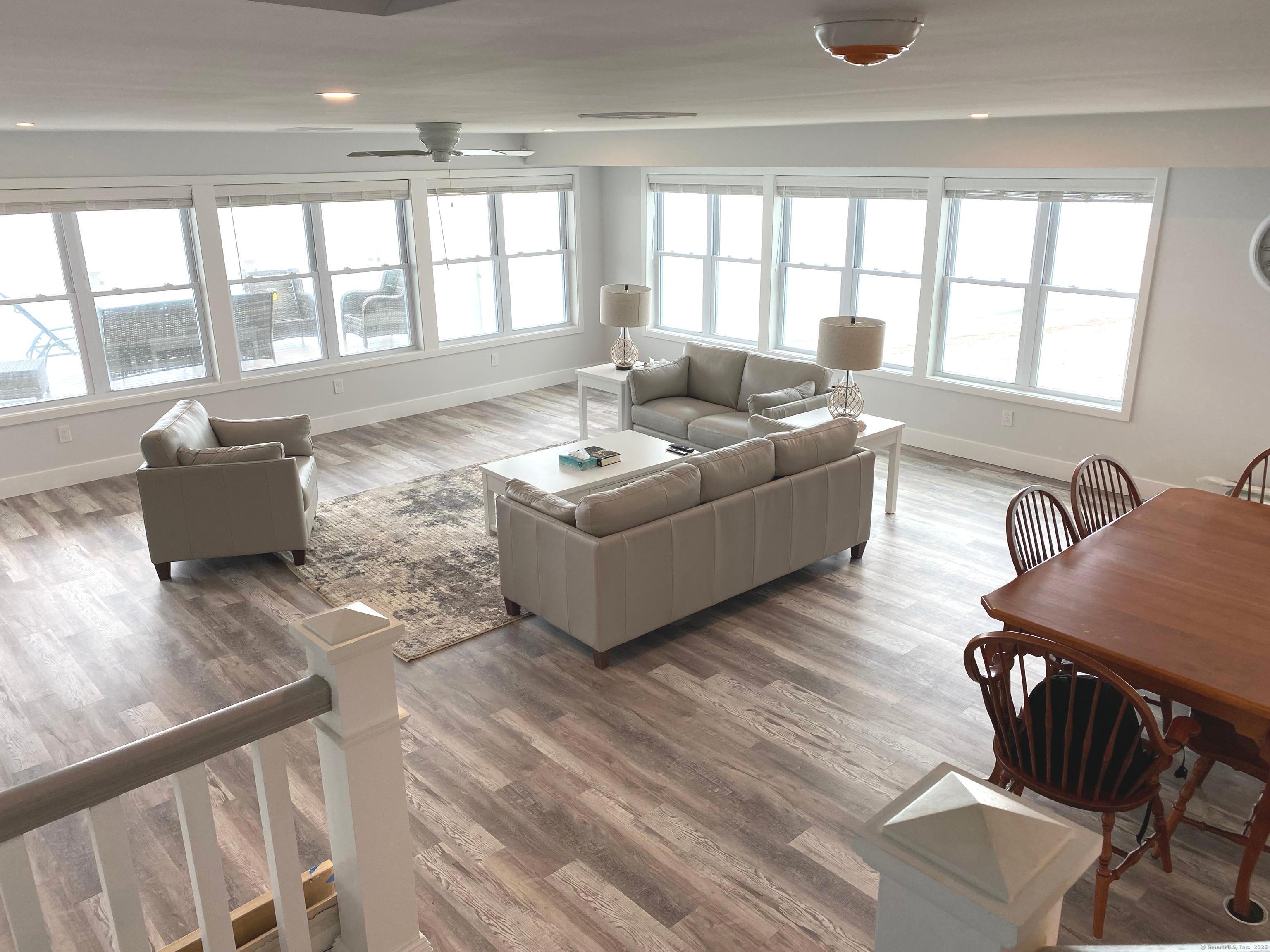 1019 Fairfield Beach Road Fairfield, CT 06824 - Photo 4 of 19 a living room with furniture and floor to ceiling windows
