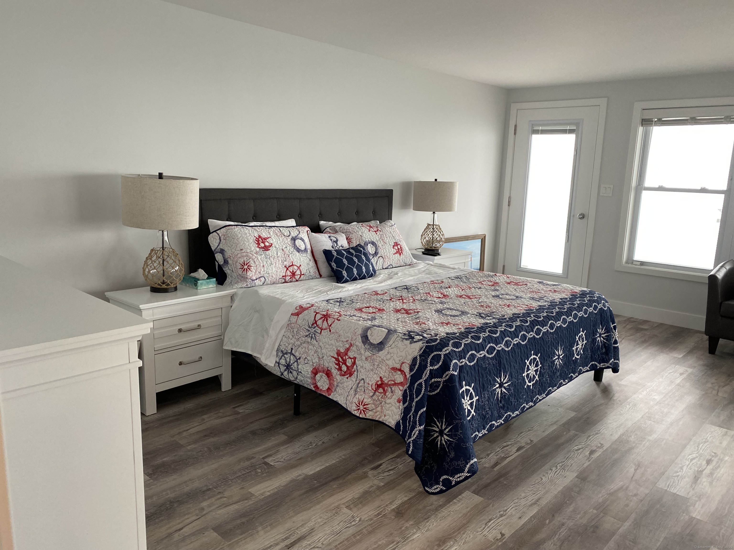 1019 Fairfield Beach Road Fairfield, CT 06824 - Photo 5 of 19 a bedroom with a bed and a window