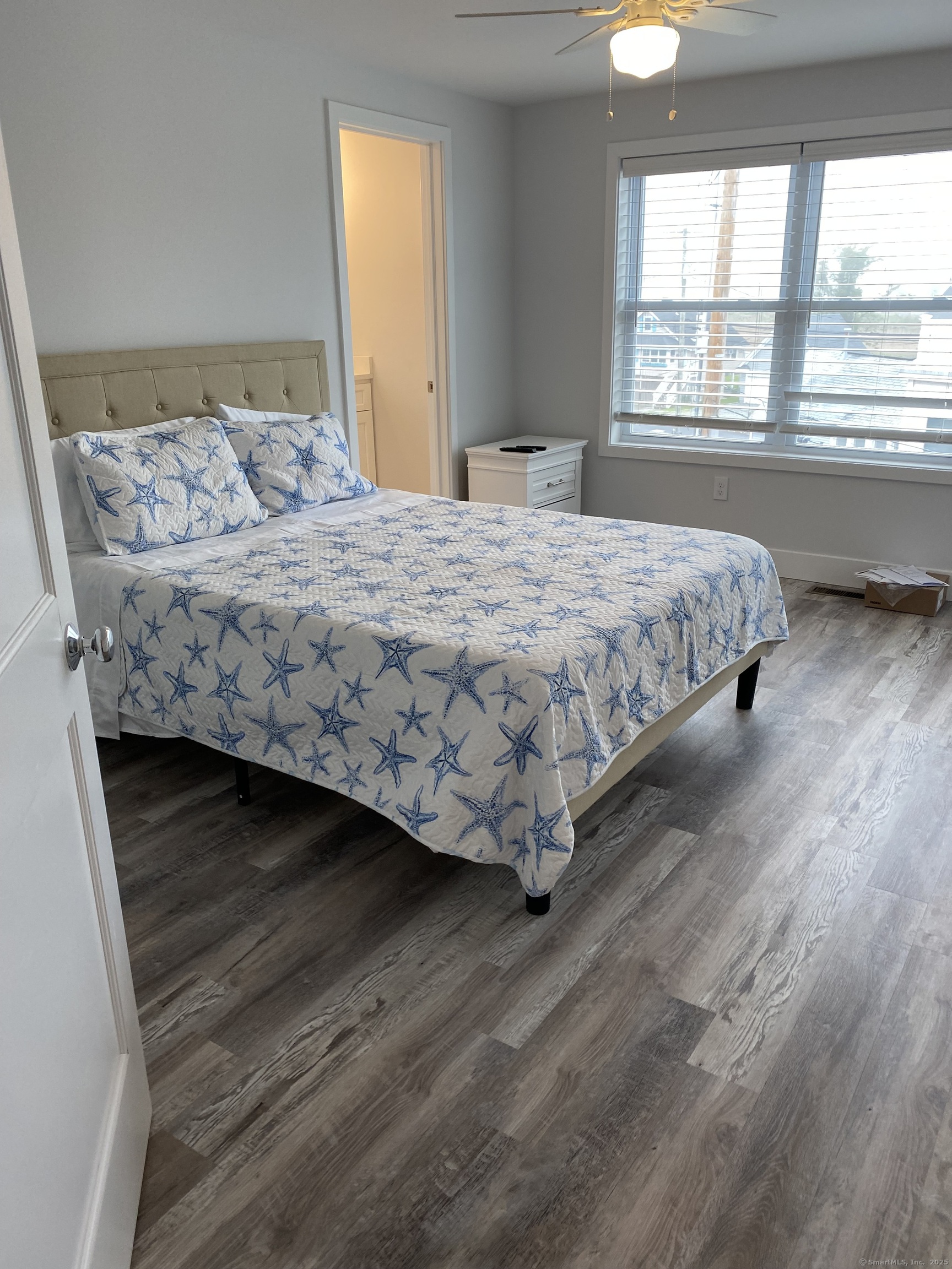 1019 Fairfield Beach Road Fairfield, CT 06824 - Photo 6 of 19 a bedroom with a bed wooden floor and window