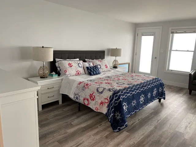 a bedroom with a bed and a window