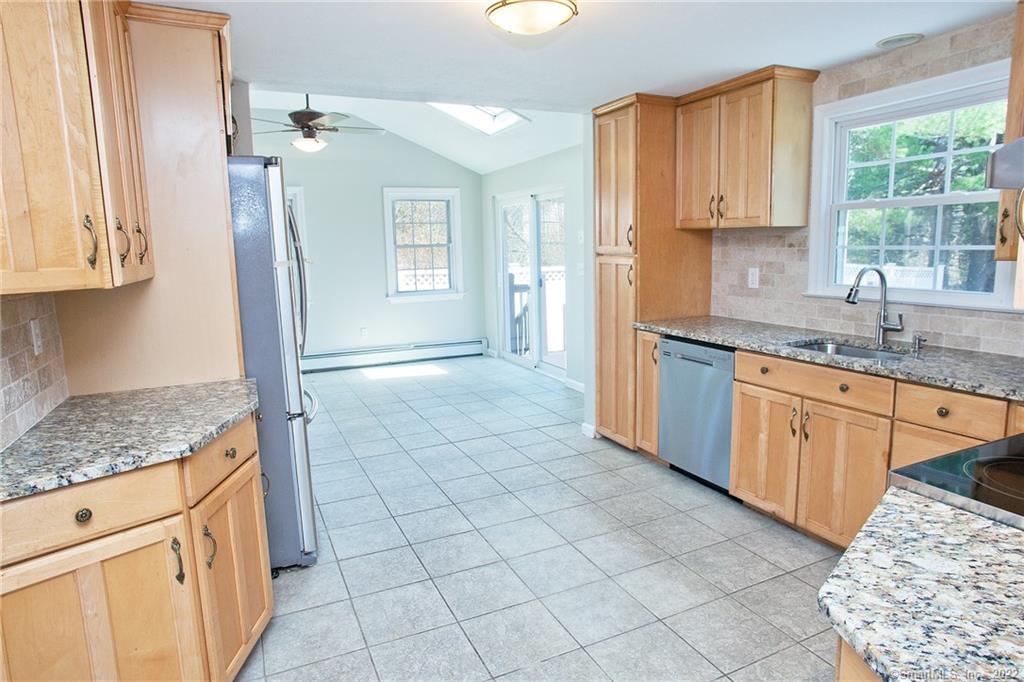a kitchen with a sink window and cabinets