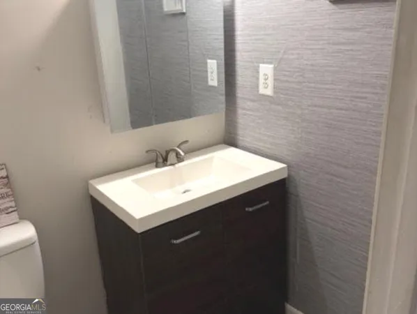a kitchen with granite countertop a stove sink and cabinets