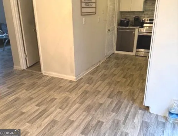 a view of a room with wooden floor and bench
