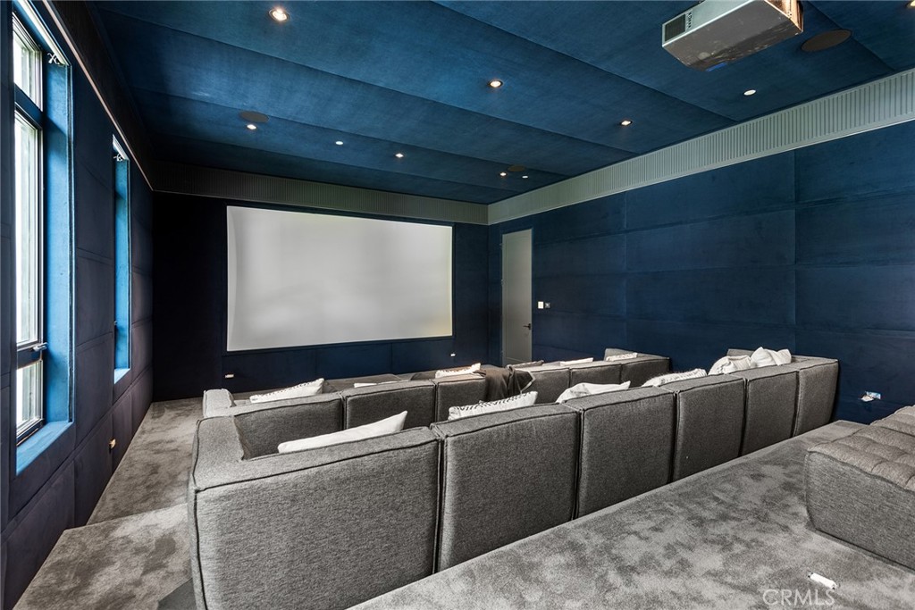 5373 Jed Smith Road Hidden Hills, CA 91302 - Photo 23 of 44 a media room with lots of chairs and a projector