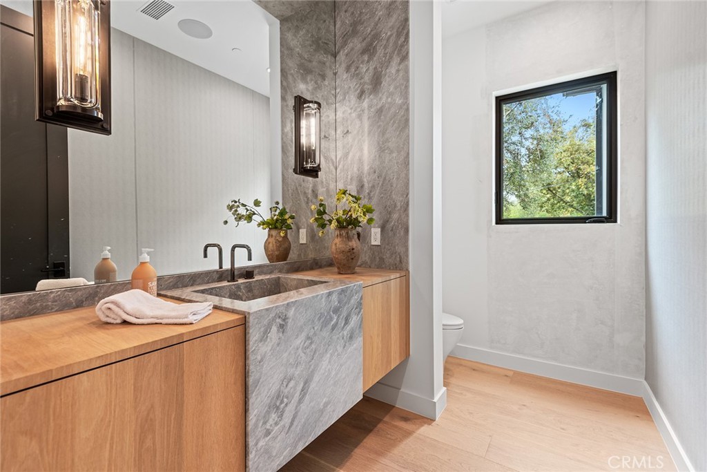 5373 Jed Smith Road Hidden Hills, CA 91302 - Photo 25 of 44 a bath room with a sink and a mirror