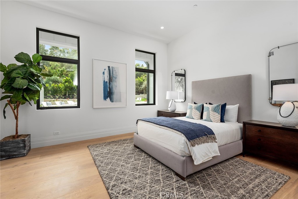 5373 Jed Smith Road Hidden Hills, CA 91302 - Photo 35 of 44 a bedroom with a bed lamp and a potted plant