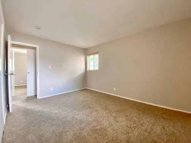an empty room with windows and closet