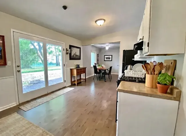 a living room with furniture and a floor to ceiling window