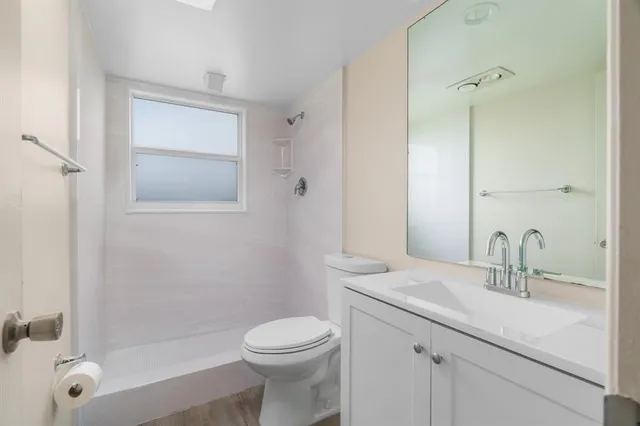 a kitchen with a refrigerator stove and white cabinets