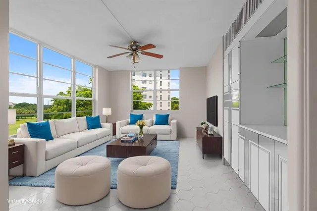 a bedroom with bed tv and view of window