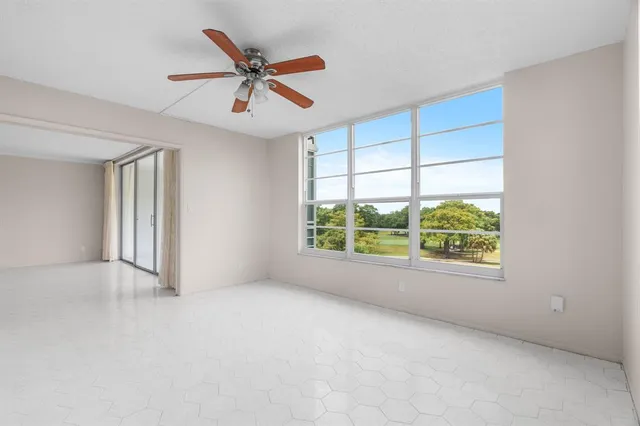 a view of a dining room with a table and chairs