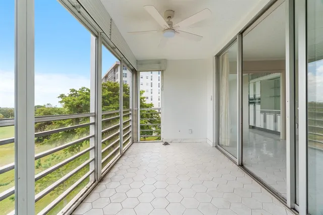 an empty room with entrance and windows