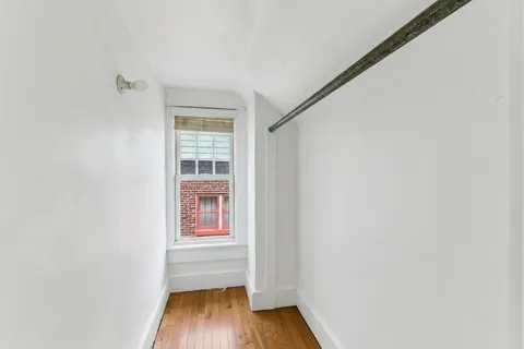 a view of small space with wooden floor and windows