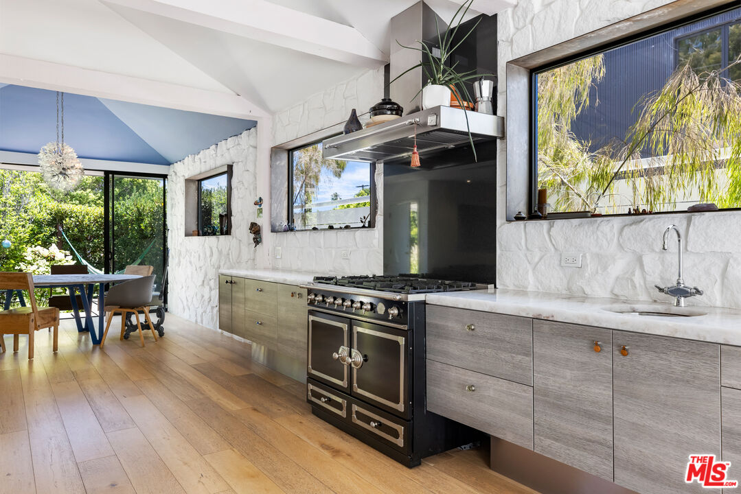 817 Palms Boulevard Venice, CA 90291 - Photo 9 of 31 a kitchen with stainless steel appliances wooden floor and a table